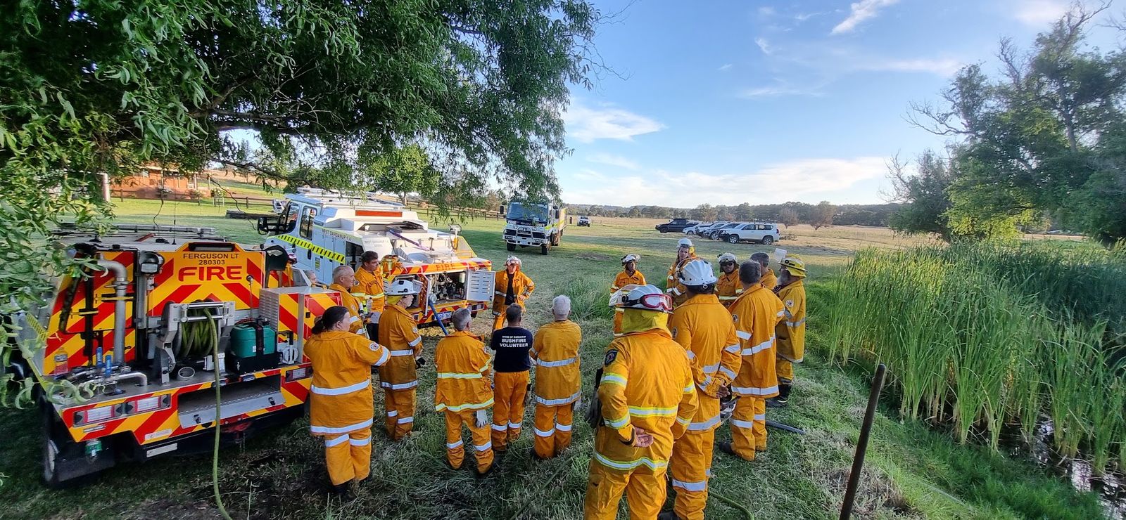 Ferguson Bushfire Brigade volunteers gathered around the brigade appliances for a briefing at a training exercise